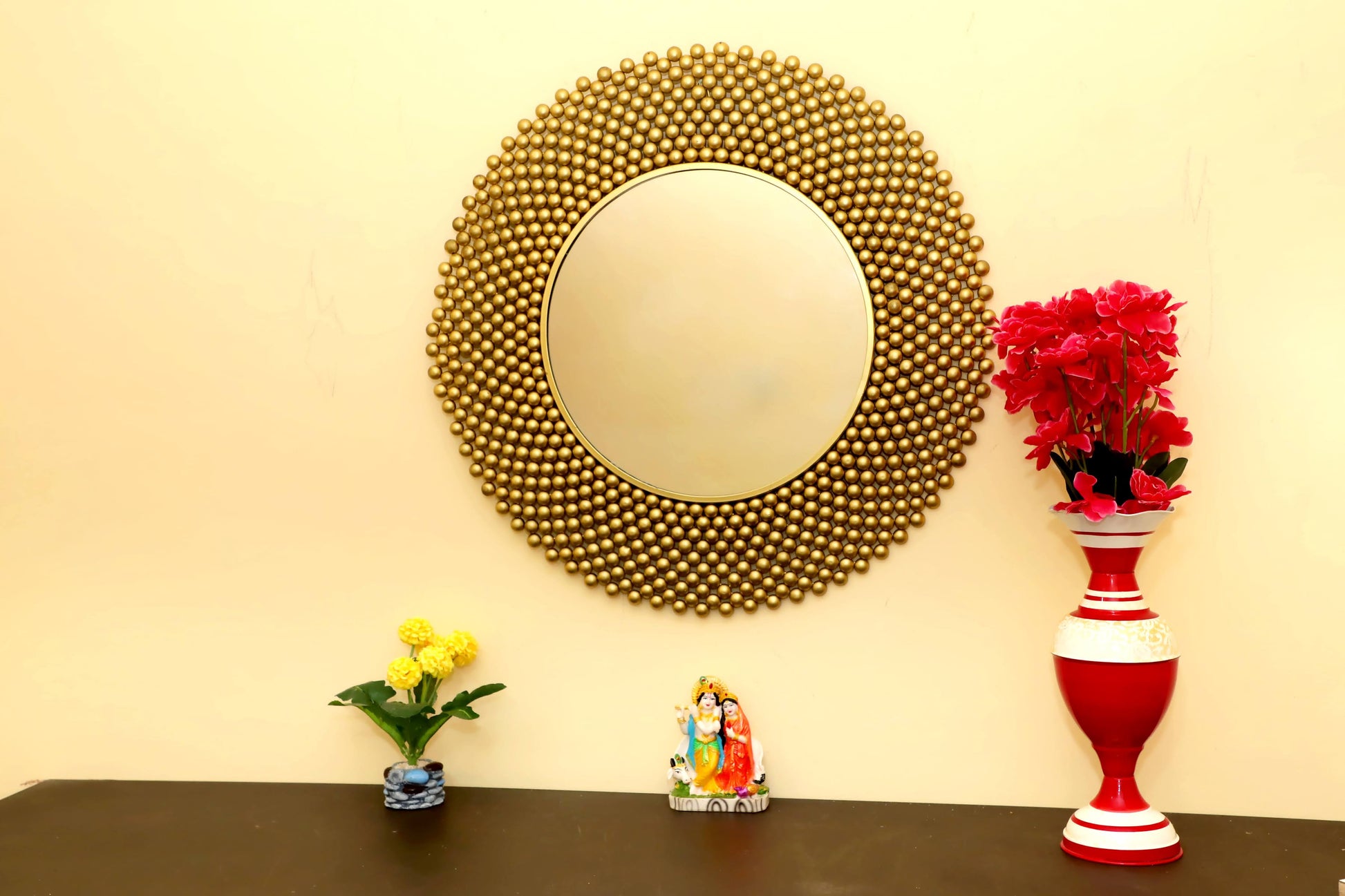 Golden round shape wall mirror, offering a luxurious accent to home decor